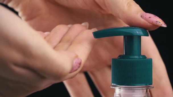 Woman Pushes Dispenser and Liquid Soap Flows Into Her Hand on Black Background — Vídeo de stock