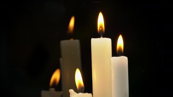 White Paraffin Candles with a Yellow Tint Burn on Black Background in Reflection — Vídeo de stock