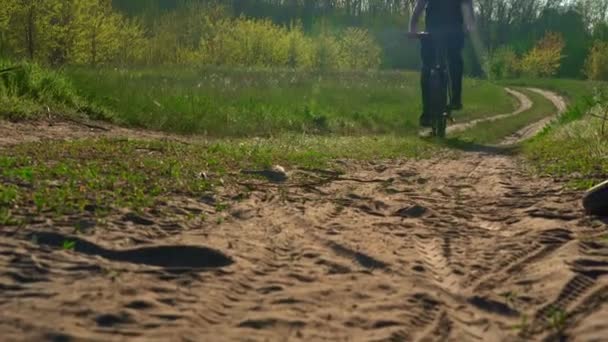 Jongeman Fietst Langs Een Stoffig Pad Het Bos Bij Zonsondergang — Stockvideo