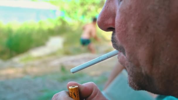 Man Lights White Cigarette Lighter Smokes Cigarette Smoke Dissipates Bad — Vídeo de stock