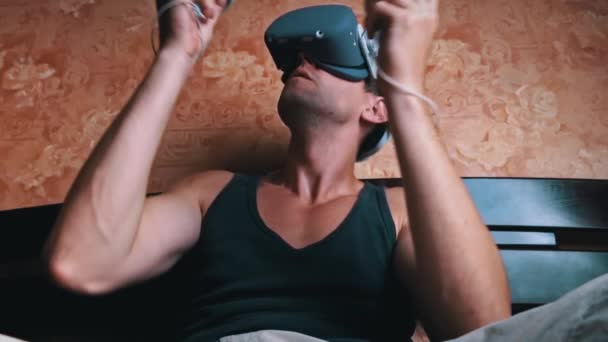 Man Virtual Reality Helmet Controls Controllers Young Man Home Sitting — Vídeo de Stock