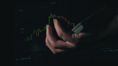 Stack of dollars falls into a hand against the background of a stock market chart. People pass from hand to hand large amount of money. Cryptocurrency funds. Value of cryptocurrency digital money