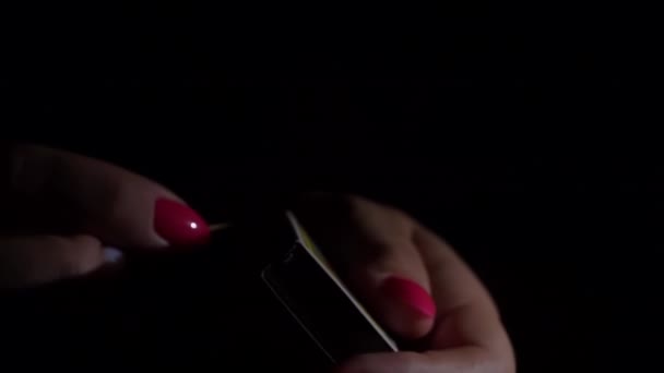 Womens Hands Light Fire Match Dark Matchbox Creates Orange Flame — Stockvideo