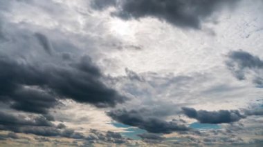 Zaman ayarlı gri yağmurlu bulutlar bulutlu bir günde karanlık gökyüzünde yüzerler. Bulutlu gökyüzü ve kasvetli bulutlar. Yağmurlu havada büyülü dramatik gökyüzü. Uğursuz bulutlar gökyüzünde yavaşça sürükleniyor, yağmuru tehdit ediyor..