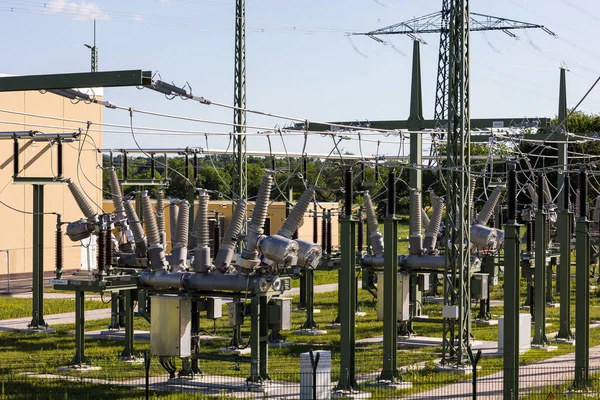 青い空と緑の牧草地のパノラマ上の電柱の電気網 — ストック写真