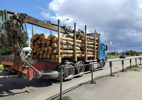 Latvia, Riga. Export of timber for export in the Riga microdistrict Bolderaja. Timber truck in motion on the road.