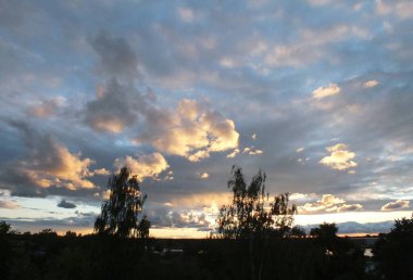 A sunny sunset. Rain clouds at sunset in the Riga neighborhood of Bolderaya.