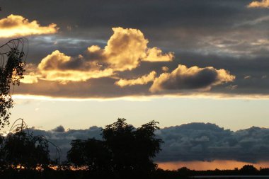 A sunny sunset. Rain clouds at sunset in the Riga neighborhood of Bolderaya.