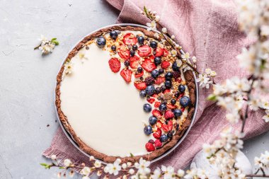 Pudding and berries fruits pastry with flowers spring decoration.	