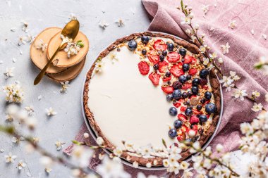 Pudding and berries fruits pastry with flowers spring decoration.	
