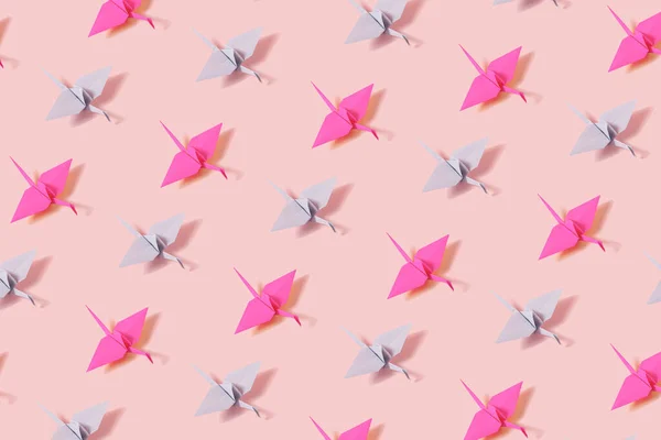 Creative Pattern Made Paper Crane Origami Figures Pastel Pink Background — стоковое фото
