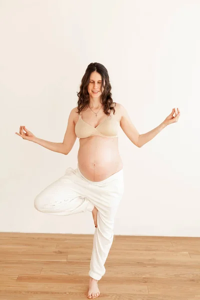 Young Beautiful Pregnant Girl Bright Room Smillig Doing Yoga Royalty Free Stock Photos