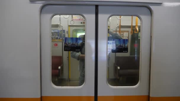 Pessoas saindo do trem em uma estação de metrô em Tóquio — Vídeo de Stock