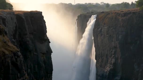 Victoria falls waterfall at sunset in Zimbabwe at the border with Zambia. — Stock Video