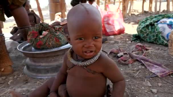 ナミビアのオプフ 5月23 アフリカのナミビアの伝統的な村でカメラを探している非常に若いヒンバの子供のクローズアップ アフリカのヒンバ族の子供 アフリカの民族集団 — ストック動画