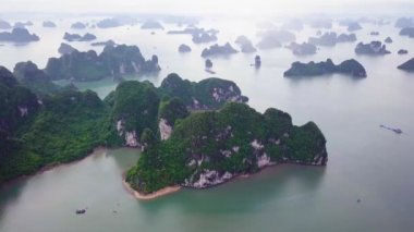 Aerial footage of Mystical Ha Long Bay in Vietnam. Flying over rocks sheer cliffs. Descending dragon. Best Travel tourism in Vietnam. High quality 4k footage Halong Bay.