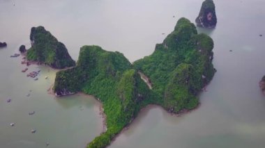 Aerial footage of Mystical Ha Long Bay in Vietnam. Flying over rocks sheer cliffs. Descending dragon. Best Travel tourism in Vietnam. High quality 4k footage Halong Bay.