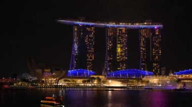 Singapore, Singapore - July 23, 22: 4K shot of Marina Bay Sands and Lotus flower building at Marina Bay. Night light show.