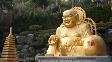 Statue of a Budai at the Haedong Yonggung temple in Busan, South Korea. High quality 4k footage