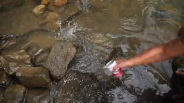 Pohnpei, Micronesia - July 23, 22: Old man is feeding a giant eel. Old man gives food to giant eels. High quality 4k footage.