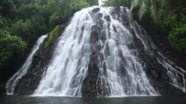 Kepirohi Waterfall inside the jungle in Pohnpei, Micronesia. Tropical exotic waterfall in wild nature of Micronesia. High quality 4k footage