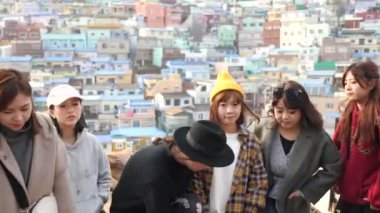 Busan, South Korea - July 23, 22: Cute Korean young girls posing for photo in Gamcheon Culture Village. Nickname is Machu Picchu of Busan. High quality 4k footage. 