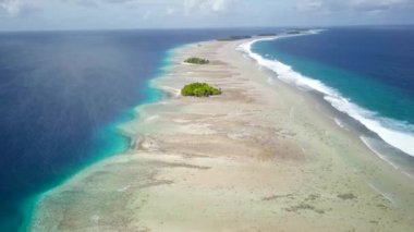 Majuro, Marshall Islands. Small tropical uninhabited island in the middle of the pacific ocean. Atoll with beautiful sandy beach surrounded by coral reef with palm trees. Aerial footage