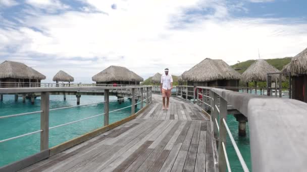 Man Walking Water Villas Bora Bora Tahiti French Polynesia Luxury — Stockvideo