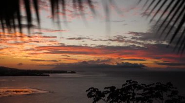 Stunning sunset at Bora Bora, Tahiti, French Polynesia. Sunset behind Moorea Island. Luxury travel vacation, romantic getaway, honeymoon exotic destination.