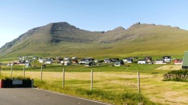 Villingadalsfjall green and rocky Summit in Faroe Islands. The top of the mountain in Faroe Islands. High quality 4k footage. Vidoy Island. Small village in Faroe Islands.
