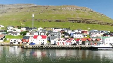 Ferry arriving at the port in Klaksvik. Kunoy Island in the background. High quality 4k footage. Bordoy Island. Klaksvik is second biggest city in Faroe Islands. Harbour full of boats in Faroe.