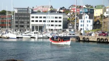 Small boat arriving to a harbour in Torshavn, Faroe Islands. High quality 4k footage