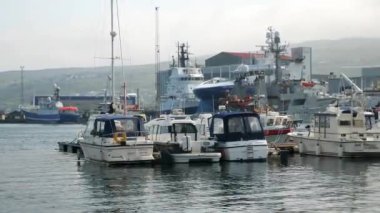 View to a Torshavn harbour in Faroe Islands. Military ship, yachts, fisher boats. High quality 4k footage