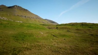 Aerial view of a faroese nature in Faroe Islands. Sunny day in summer. Amazing nature in Faroe Islands. The top of the Summits in Faroe islands. Eysturoy Island. Birds on the footage.