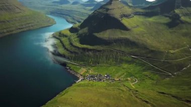 Aerial view of Funningur village, Faroe Islands. Sunny day in summer. Amazing nature in Faroe Islands. Eysturoy Island. Gonguturur or Hvithamar Trailhead. Faroese fjord and summits.