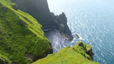 Amazing Faroese nature, green hills and beautiful rocky cliffs and mountains. View from a Kalsoy Island. Sunny day in summer. Movie Island in Faroe. High quality 4k footage