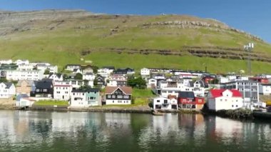 Ferry arriving at the port in Klaksvik. Kunoy Island in the background. High quality 4k footage. Bordoy Island. Klaksvik is second biggest city in Faroe Islands. Harbour full of boats in Faroe.