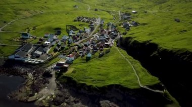 Aerial view of a canyon in Gjogv village in Faroe Islands. Sunny day in summer. Amazing nature in Faroe Islands. Eysturoy. Faroese canyon. Natural harbour in Gjogv. Slaettaratindur in the background.