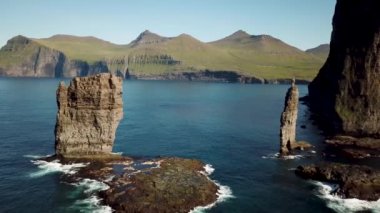 Aerial view of a Rock formation Risin og Kellingin in Faroe Islands. The giant and the witch from Iceland who tried to steal the Faroe Islands. Sunny day in summer. High quality 4k footage.