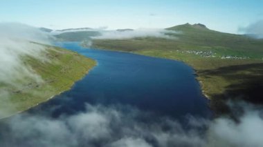 Aerial view of Sorvagsvatn lake or Leitisvatn, Biggest lake in Faroe Islands. Flying through the clouds. Amazing mist and foggy Faroese nature. High quality 4k footage.