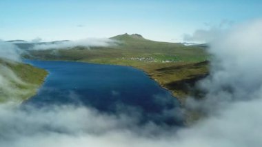 Aerial view of Sorvagsvatn lake or Leitisvatn, Biggest lake in Faroe Islands. Flying through the clouds. Amazing mist and foggy Faroese nature. High quality 4k footage.