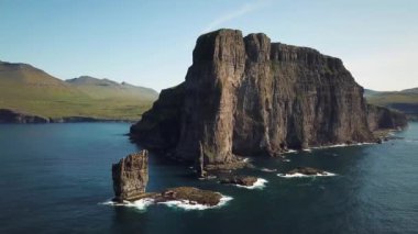 Aerial view of a Rock formation Risin og Kellingin in Faroe Islands. The giant and the witch from Iceland who tried to steal the Faroe Islands. Sunny day in summer. High quality 4k footage.