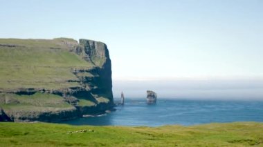 Rock formation Risin og Kellingin in Faroe Islands. The giant and the witch from Iceland who tried to steal the Faroe Islands. High quality 4k footage.