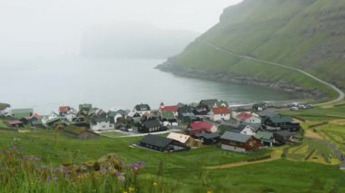 Faroese village of Tjornuvik. Old faroese houses in the middle of mist faroese nature. Typical old house in Faroe Islands with a Grass rooftop. Grass covered house. High quality 4k footage. 