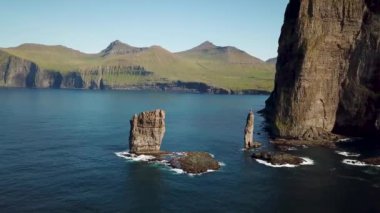 Aerial view of a Rock formation Risin og Kellingin in Faroe Islands. The giant and the witch from Iceland who tried to steal the Faroe Islands. Sunny day in summer. High quality 4k footage.