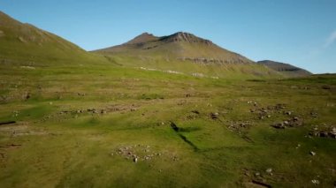 Aerial view of a faroese nature in Faroe Islands. Sunny day in summer. Amazing nature in Faroe Islands. The top of the Summits in Faroe islands. Eysturoy Island. Birds on the footage.