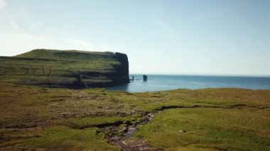 Aerial view of a Rock formation Risin og Kellingin in Faroe Islands. The giant and the witch from Iceland who tried to steal the Faroe Islands. Sunny day in summer. High quality 4k footage.
