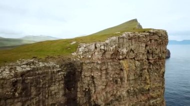 Aerial view of Slave cliff or Traelanipan and Sorvagsvatn lake or Leitisvatn, Biggest lake in Faroe Islands. High quality 4k footage. Amazing nature. Huge cliffs. Lake above the ocean.