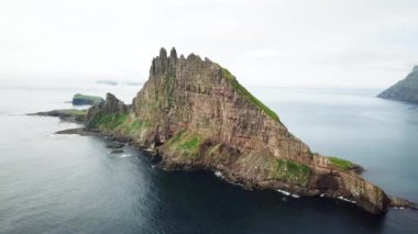Aerial drone view of the islet Tindholmur in the Atlantic Ocean in Faroe Islands. High quality 4k footage. Rock formations.