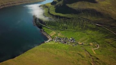 Aerial view of Funningur village, Faroe Islands. Sunny day in summer. Amazing nature in Faroe Islands. Eysturoy Island. Gonguturur or Hvithamar Trailhead. Faroese fjord and summits.